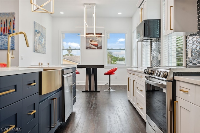 8605 Inwood Dr, Hudson, FL 34667 - kitchen with stainless steel appliances, dark wood-style flooring, white cabinets, and recessed lighting