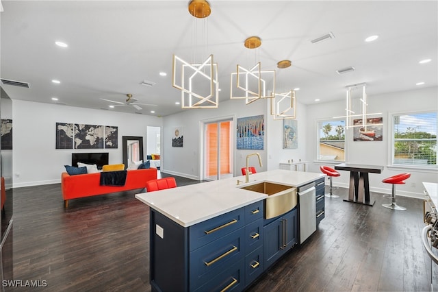 8605 Inwood Dr, Hudson, FL 34667 - kitchen featuring dishwasher, dark wood-style flooring, recessed lighting, light countertops, and blue cabinets
