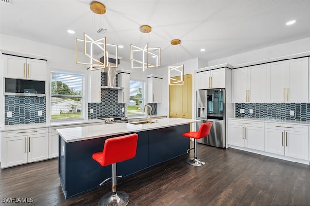 8605 Inwood Dr, Hudson, FL 34667 - kitchen with appliances with stainless steel finishes, backsplash, light countertops, dark wood-type flooring, and decorative light fixtures