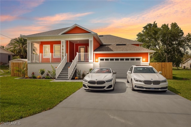 8605 Inwood Dr, Hudson, FL 34667 - view of front facade with a garage, driveway, covered porch, roof with shingles, and stairs