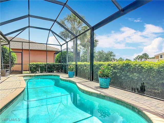 10843 Valentina Ct, Fort Myers, FL 33913 - outdoor pool with glass enclosure and a patio area