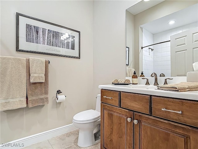 10843 Valentina Ct, Fort Myers, FL 33913 - bathroom with toilet, tiled shower, vanity, and baseboards