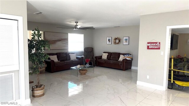 1005 E Penn Rd, Lehigh Acres, FL 33936 - living room with a ceiling fan, baseboards, visible vents, and marble finish floor