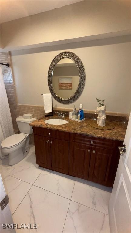 1005 E Penn Rd, Lehigh Acres, FL 33936 - bathroom featuring vanity, marble finish floor, and toilet