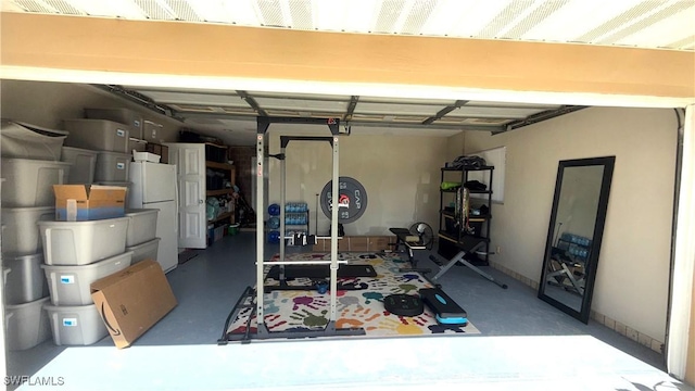 1005 E Penn Rd, Lehigh Acres, FL 33936 - garage featuring freestanding refrigerator