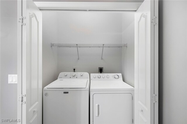 washroom featuring washer and dryer