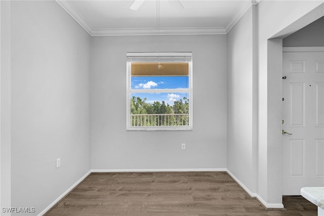 unfurnished room featuring crown molding, wood finished floors, and baseboards