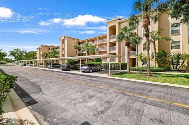 view of apartment building / complex with covered parking