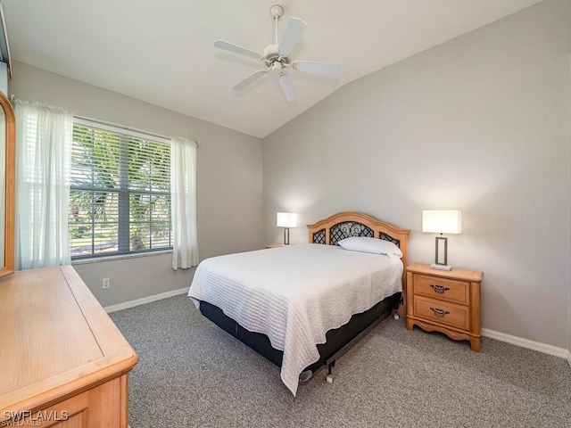 bedroom with vaulted ceiling, light colored carpet, baseboards, and a ceiling fan