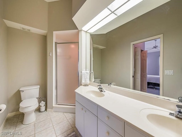 full bath with toilet, a stall shower, tile patterned flooring, double vanity, and baseboards