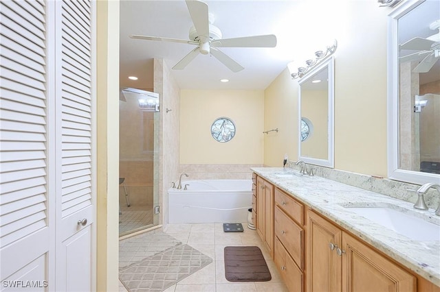 full bathroom with tile patterned floors, a ceiling fan, a bath, a shower stall, and double vanity
