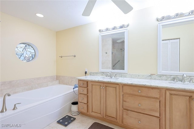 full bath with tile patterned floors, double vanity, a bath, and ceiling fan