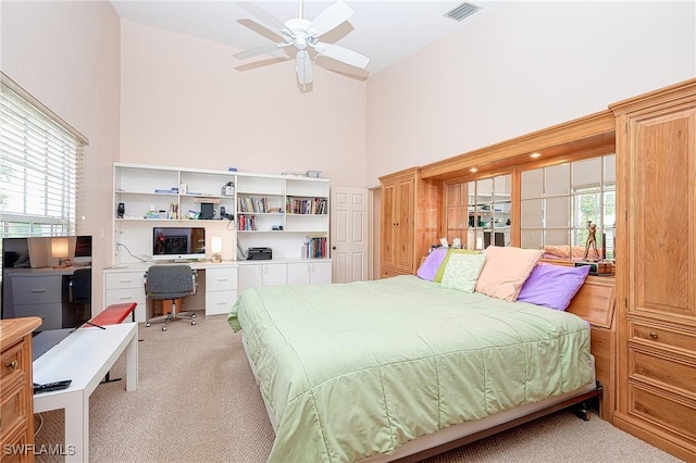 bedroom featuring high vaulted ceiling, light colored carpet, a desk, multiple windows, and ceiling fan