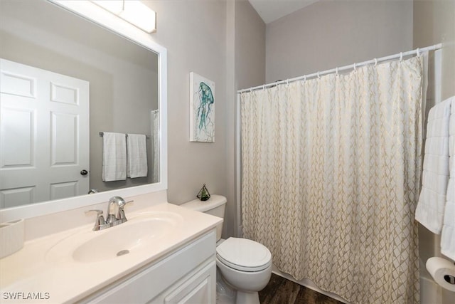 bathroom featuring vanity, wood finished floors, toilet, and curtained shower