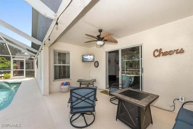 view of patio with glass enclosure, ceiling fan, and an outdoor pool