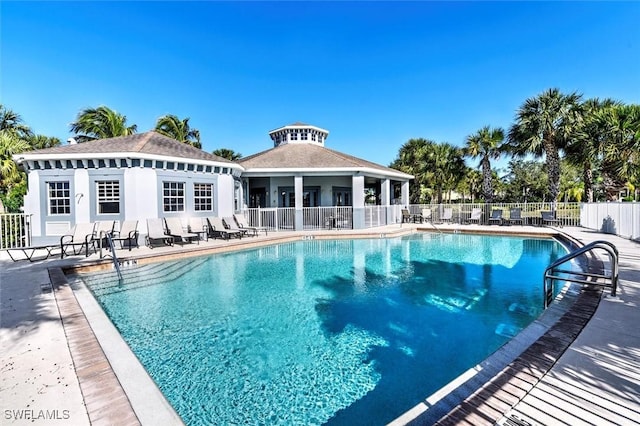 pool with a patio and fence