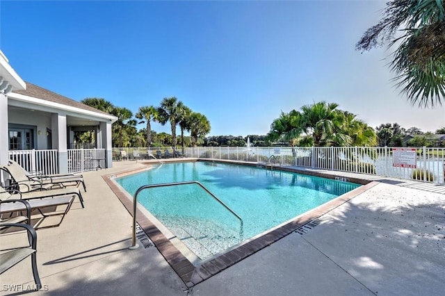 pool with fence and a patio