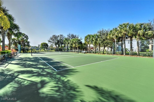 view of tennis court featuring fence