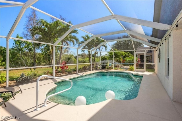 outdoor pool featuring a lanai and a patio area