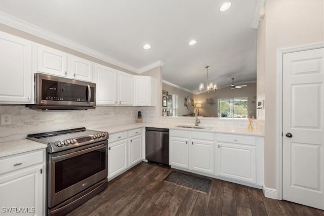 kitchen featuring ornamental molding, dark wood-type flooring, tasteful backsplash, a sink, and stainless steel appliances