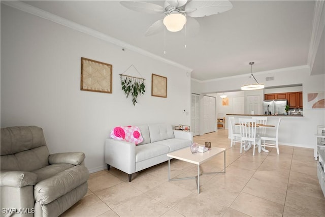 living room featuring light tile patterned floors, ornamental molding, a ceiling fan, and visible vents