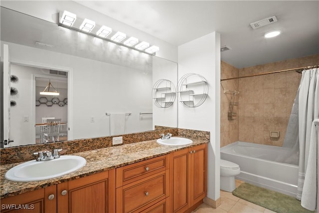 bathroom with a sink, tile patterned flooring, double vanity, and visible vents