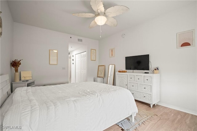 bedroom with a ceiling fan, a closet, baseboards, visible vents, and light wood-type flooring