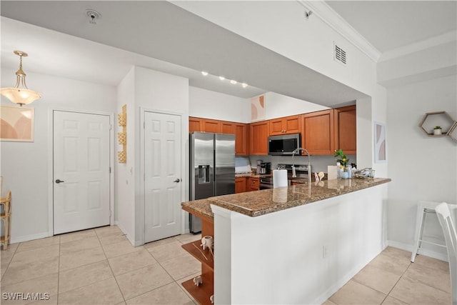 kitchen featuring a peninsula, stainless steel appliances, brown cabinets, visible vents, and light tile patterned floors