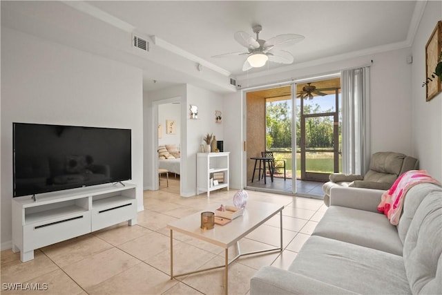 living room with ornamental molding, visible vents, ceiling fan, light tile patterned floors, and baseboards
