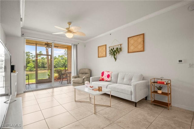 living area featuring ornamental molding, light tile patterned flooring, a ceiling fan, and baseboards