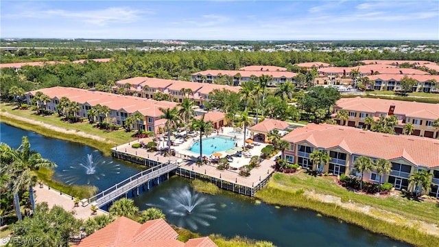 drone / aerial view featuring a water view and a residential view