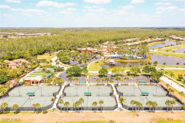 birds eye view of property featuring a residential view, a water view, and a wooded view