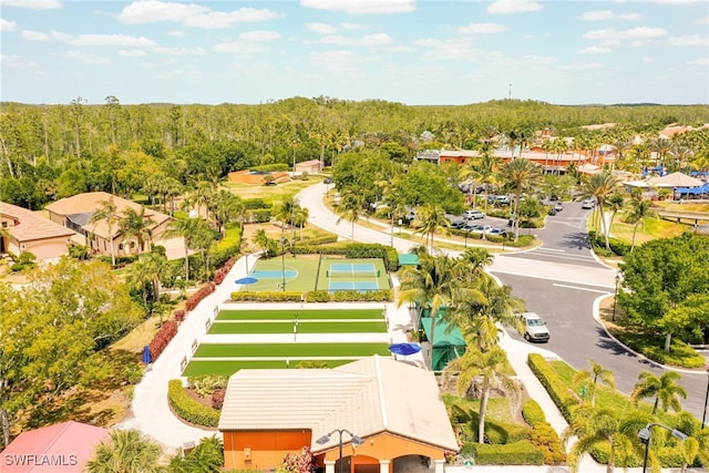 drone / aerial view featuring a residential view and a wooded view