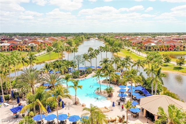 drone / aerial view with a water view and a residential view