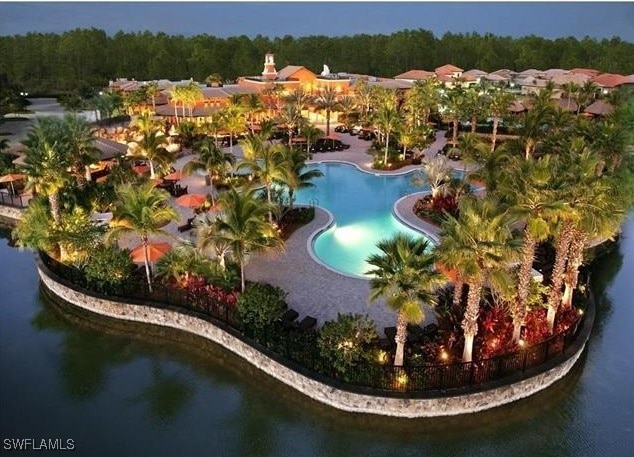 community pool featuring a water view and a view of trees