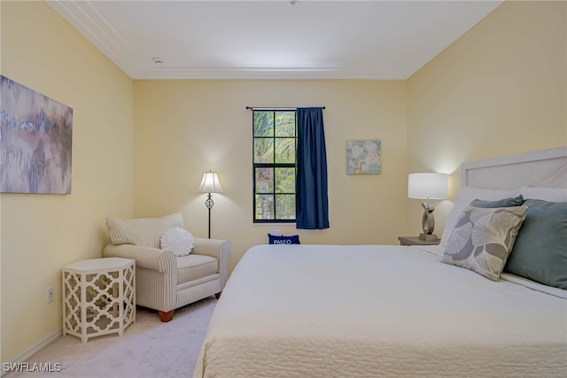 carpeted bedroom featuring baseboards and ornamental molding