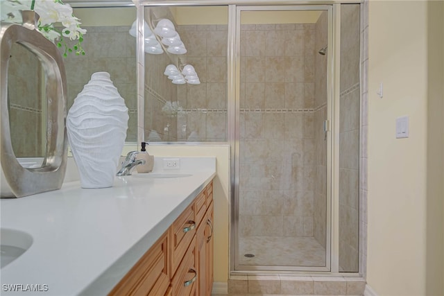 full bath with a shower stall and vanity