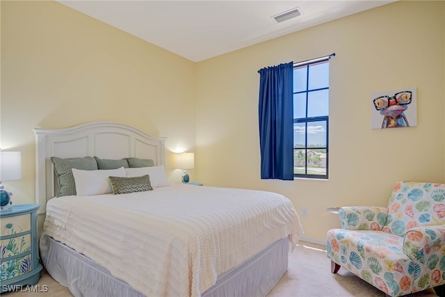 carpeted bedroom featuring baseboards and visible vents