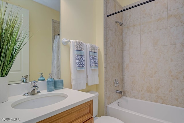 bathroom with toilet, bathing tub / shower combination, and vanity