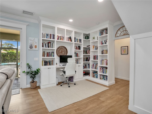 office space with visible vents, light wood-type flooring, baseboards, ornamental molding, and recessed lighting