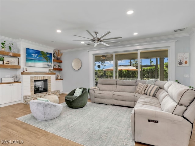 living area with crown molding, a ceiling fan, and a wealth of natural light