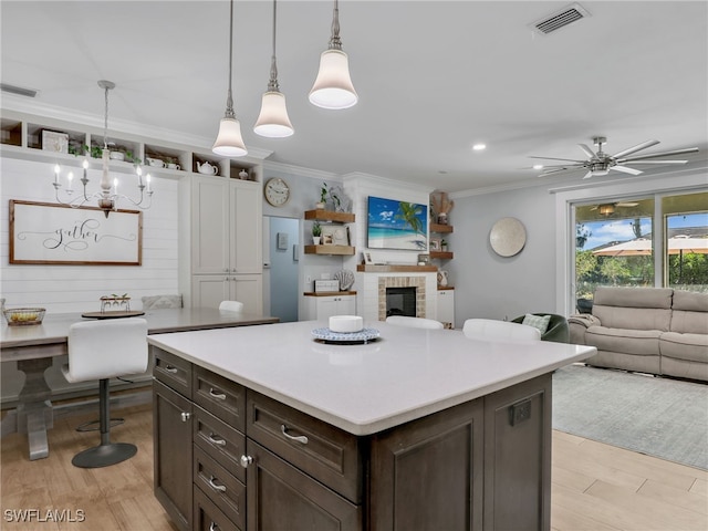 kitchen with visible vents, light countertops, and open floor plan