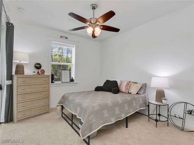 carpeted bedroom featuring a ceiling fan and baseboards