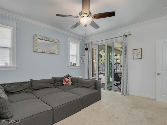 carpeted living area featuring crown molding, a ceiling fan, and baseboards