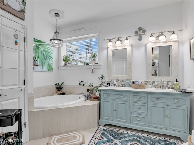 full bath featuring double vanity, an inviting chandelier, a sink, and a bath