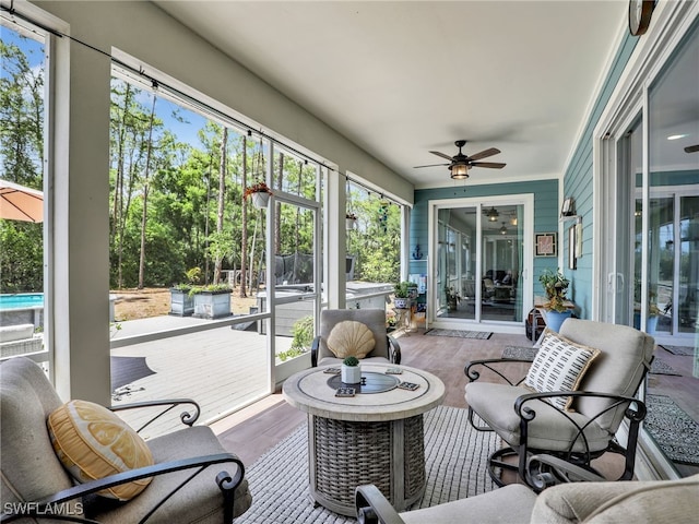 sunroom / solarium featuring ceiling fan