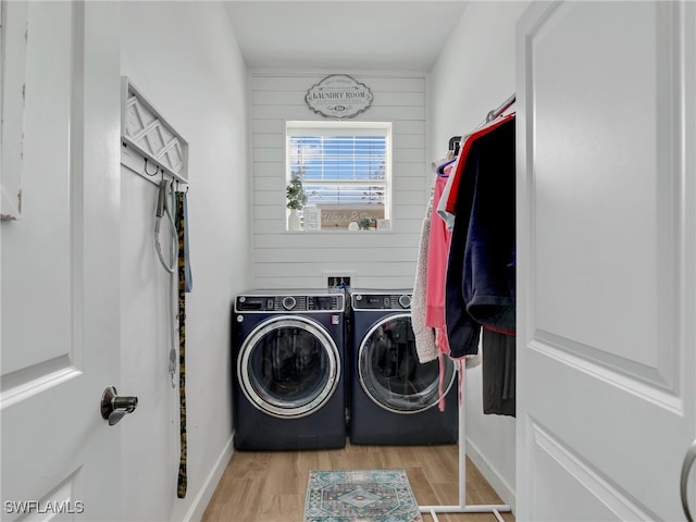 laundry area with separate washer and dryer, laundry area, and wood finished floors