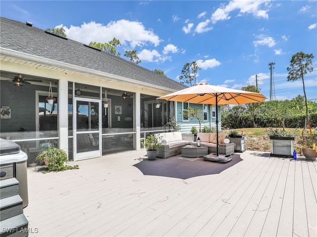 wooden deck with a sunroom, an outdoor living space, and ceiling fan