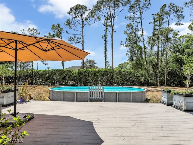 wooden deck with an outdoor pool