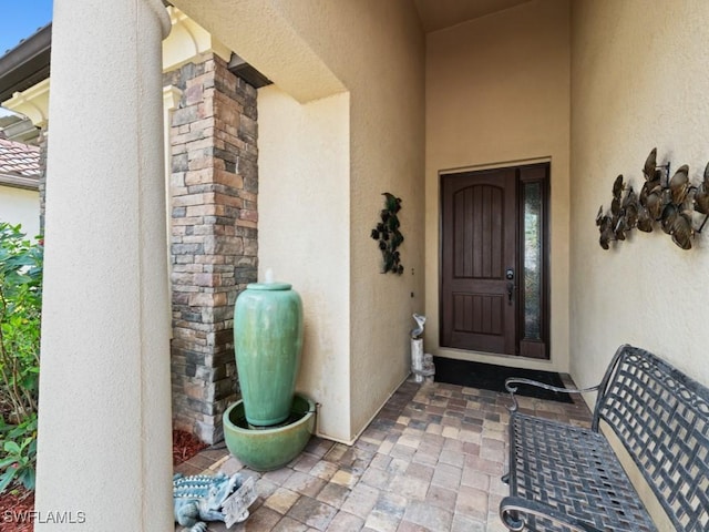 property entrance featuring stucco siding
